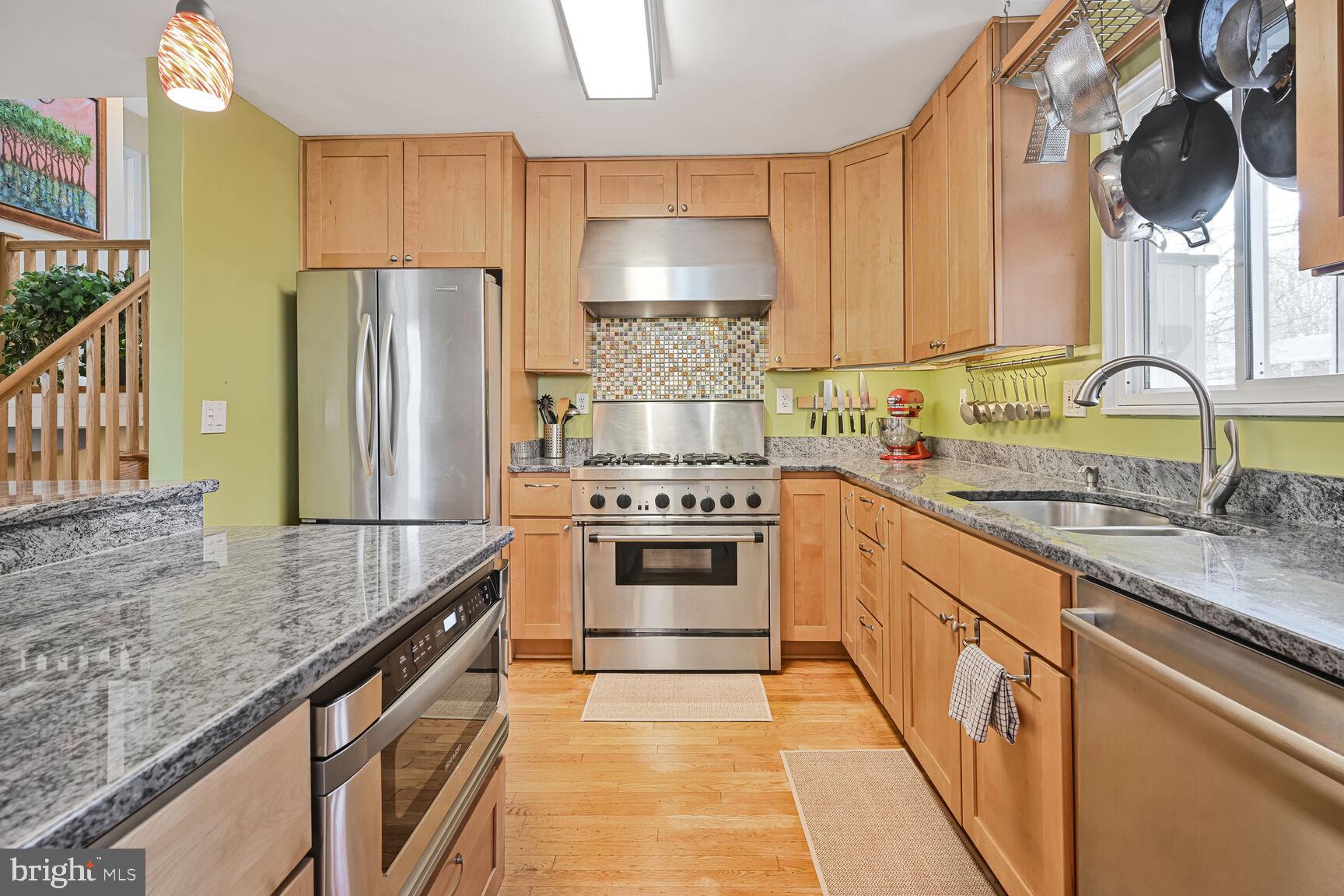 2308 Peggy Lane Silver Spring, MD 20910 - Photo 8 of 27 a kitchen with stainless steel appliances granite countertop a sink stove and refrigerator