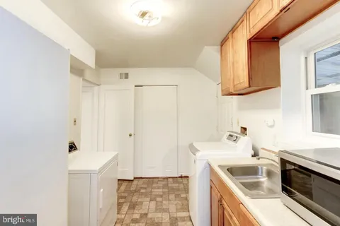 a kitchen with stainless steel appliances a stove a sink and a refrigerator
