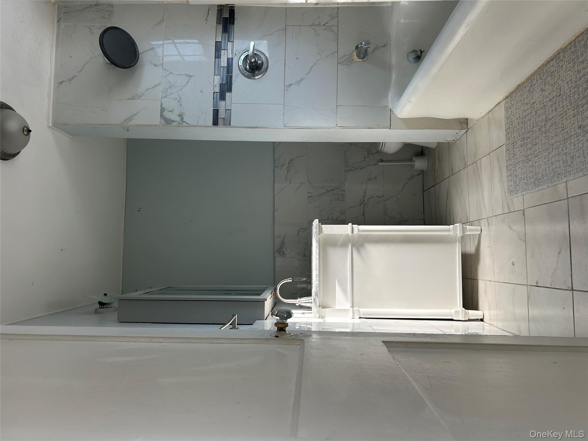 139 Derby Street Valley Stream, NY 11581 - Photo 5 of 14 a bathroom with a sink a toilet and shower