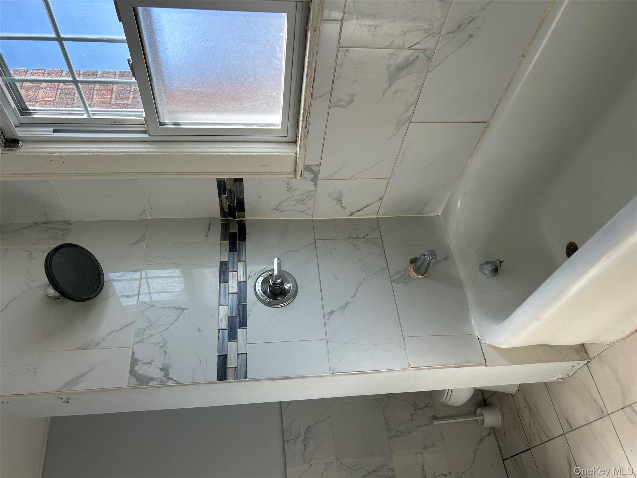 139 Derby Street Valley Stream, NY 11581 - Photo 6 of 14 a bathroom with a tub and a sink