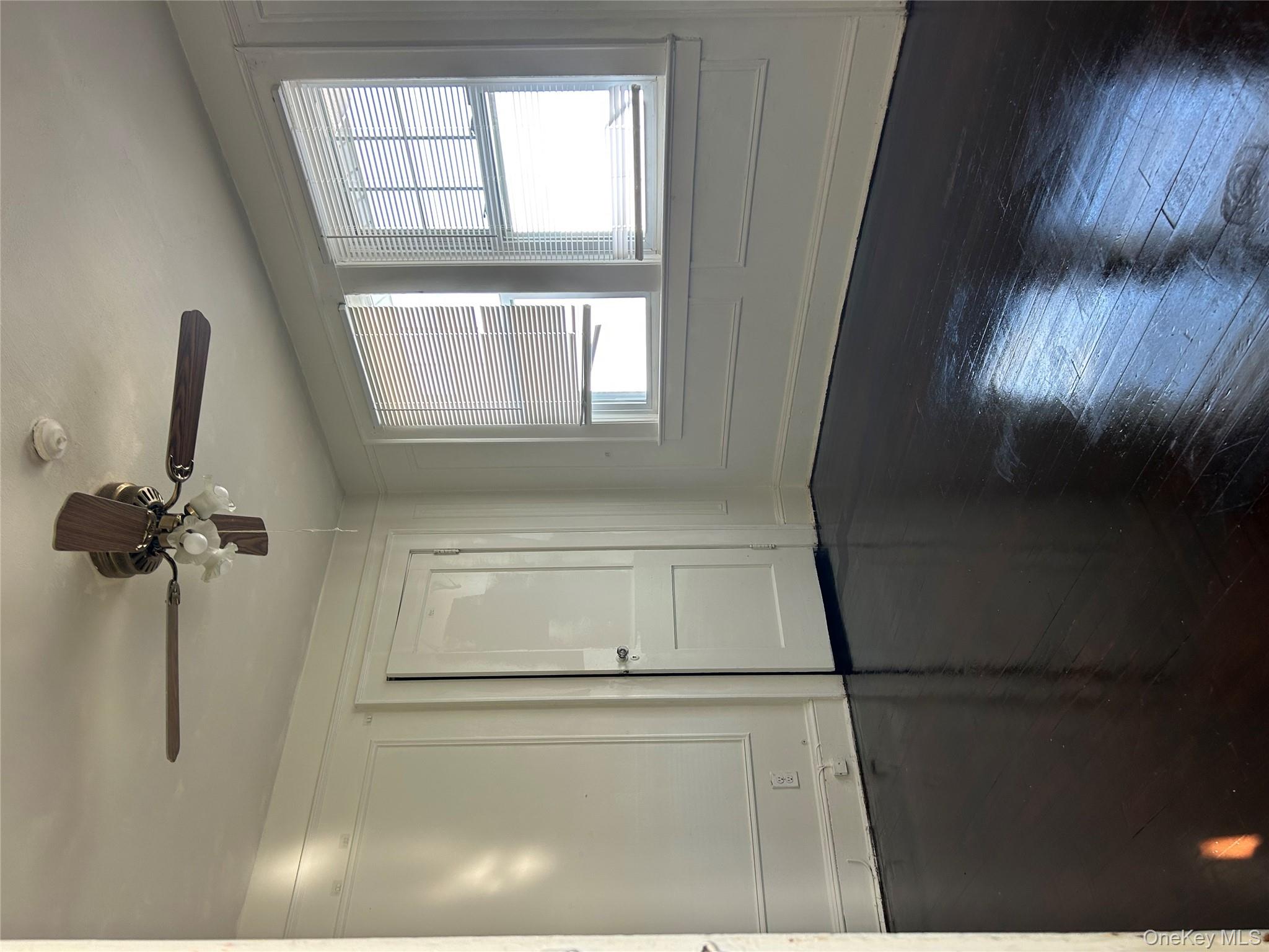 139 Derby Street Valley Stream, NY 11581 - Photo 7 of 14 a view of an empty room with wooden floor and a window