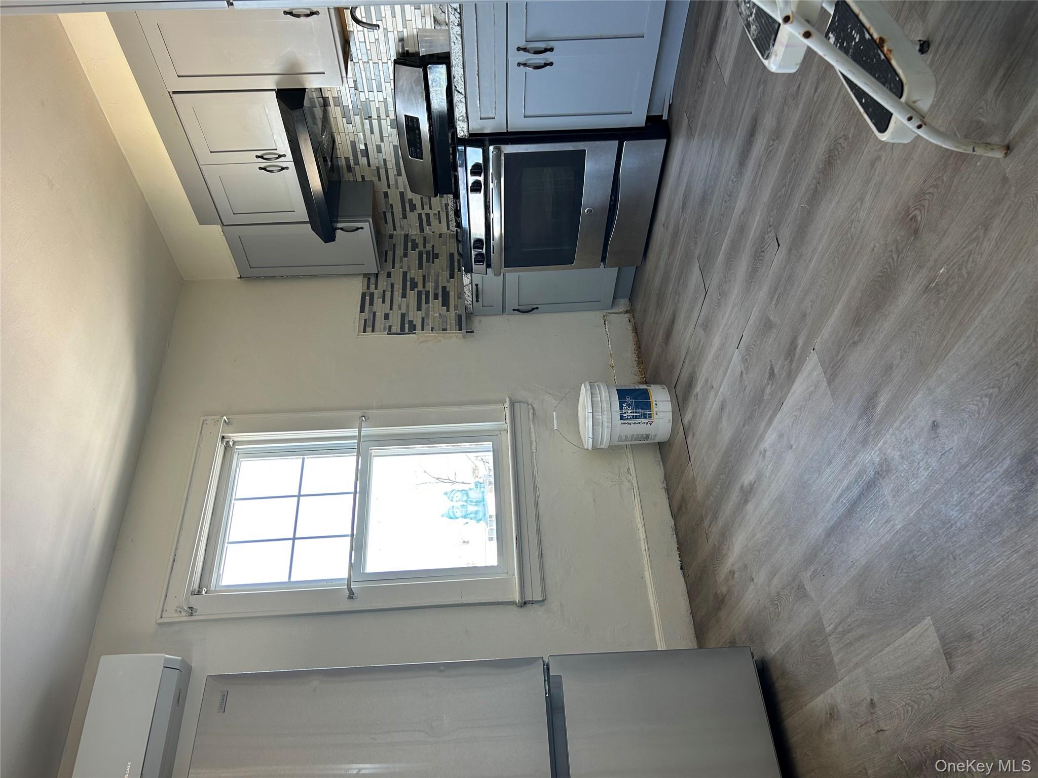 139 Derby Street Valley Stream, NY 11581 - Photo 9 of 14 a kitchen with granite countertop a stove a sink and a refrigerator