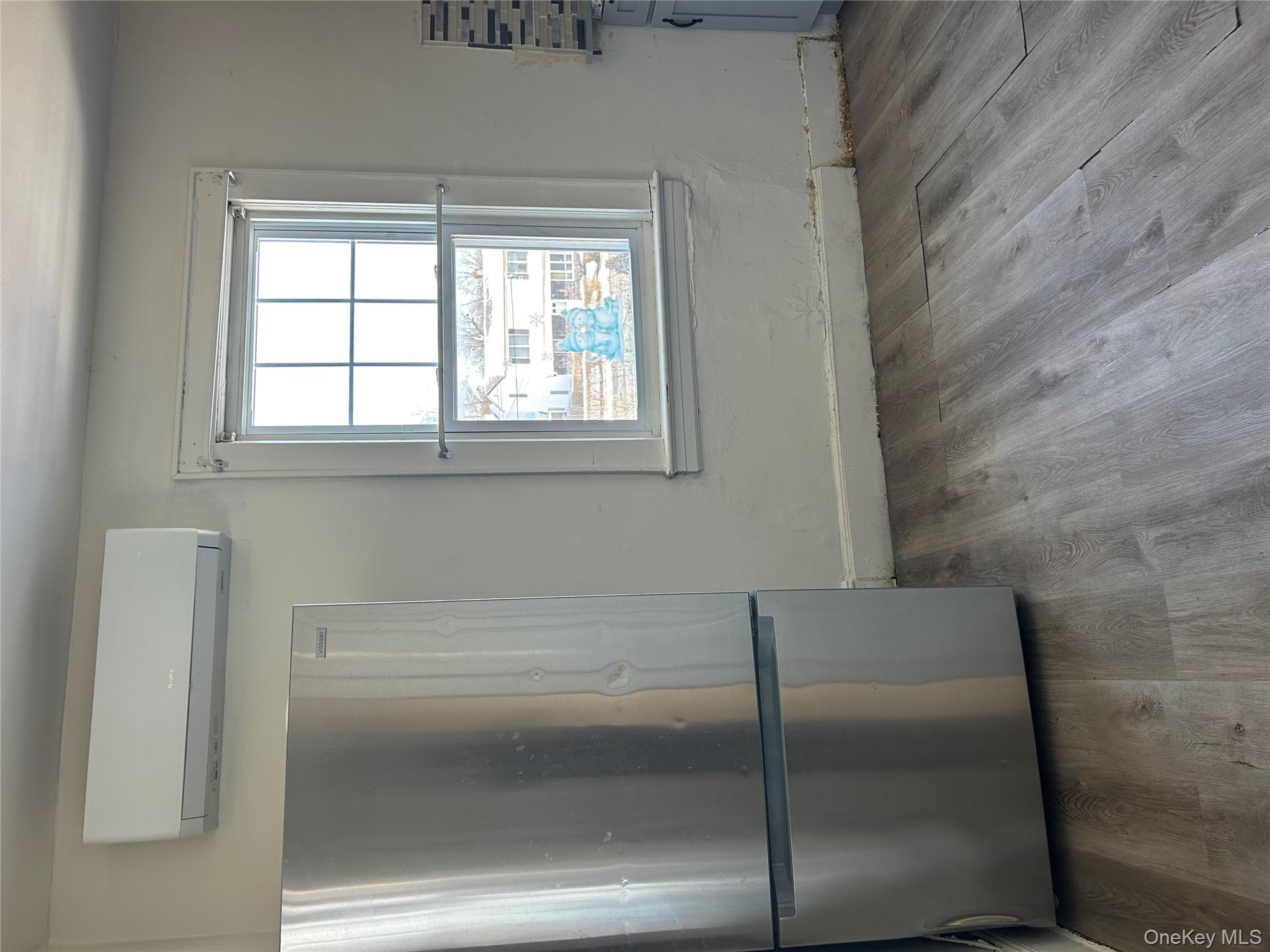 139 Derby Street Valley Stream, NY 11581 - Photo 10 of 14 a view of empty room with wooden floor and fan