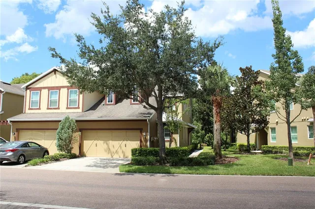 a front view of a house with a garden and garage