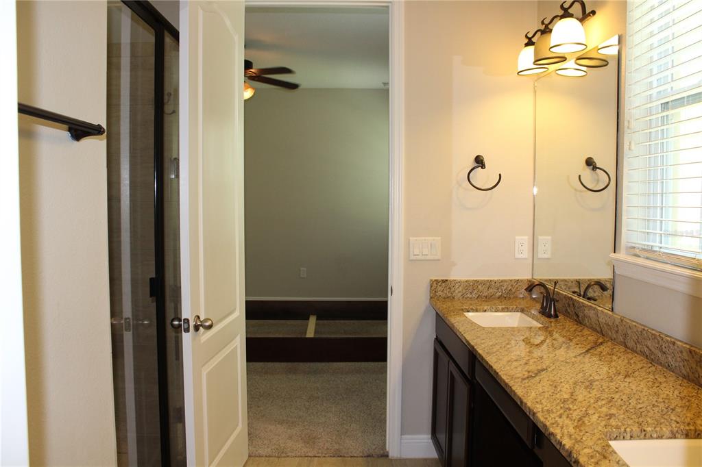 131 Villa Preserve Avenue Tampa, FL 33613 - Photo 18 of 28 a bathroom with a granite countertop sink a mirror and shower