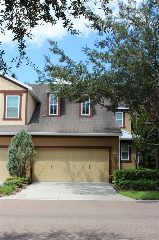 131 Villa Preserve Avenue Tampa, FL 33613 - Photo 2 of 28 a front view of a house with a garden