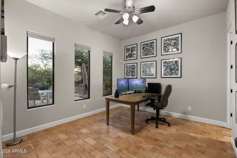 a view of a workspace with furniture and a window