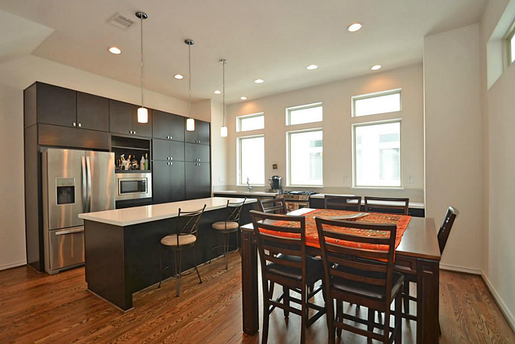 2713 Clay Street Houston, TX 77003 - Photo 2 of 24 Great kitchen/dining room combo which features quartz countertops, plenty of storage & a breakfast bar.