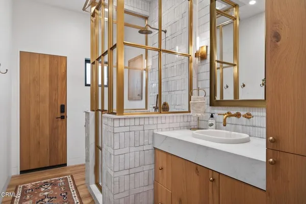 a bathroom with a granite countertop sink double and mirror