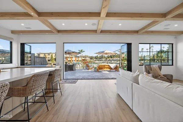 a dining hall with stainless steel appliances granite countertop a stove and a refrigerator