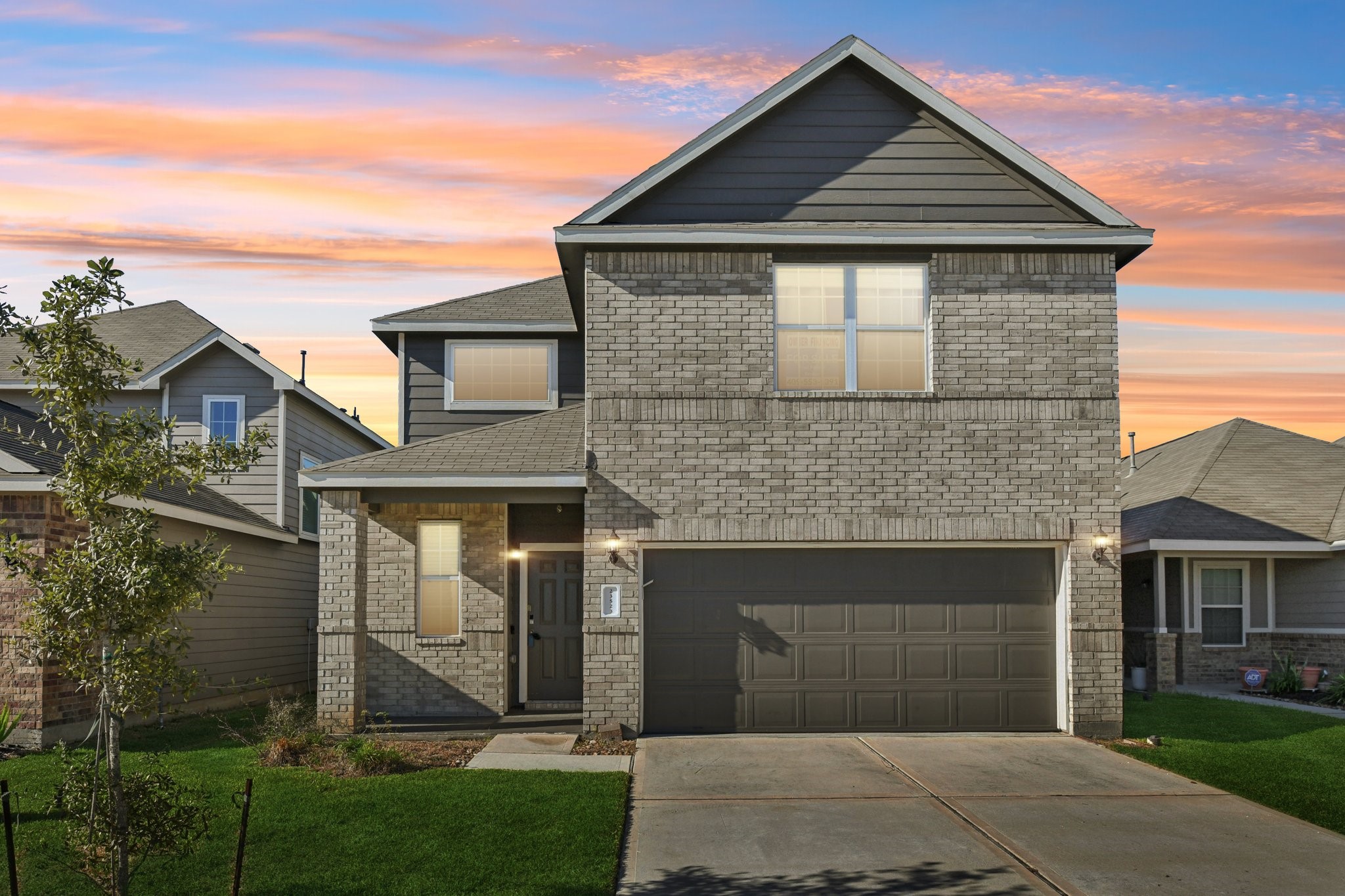 a front view of a house with a yard