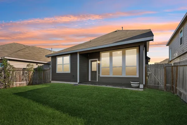 a view of house with backyard