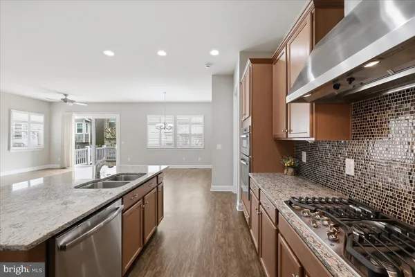 a kitchen with granite countertop a stove and a sink