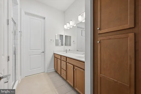 a bathroom with a double vanity sink and a mirror