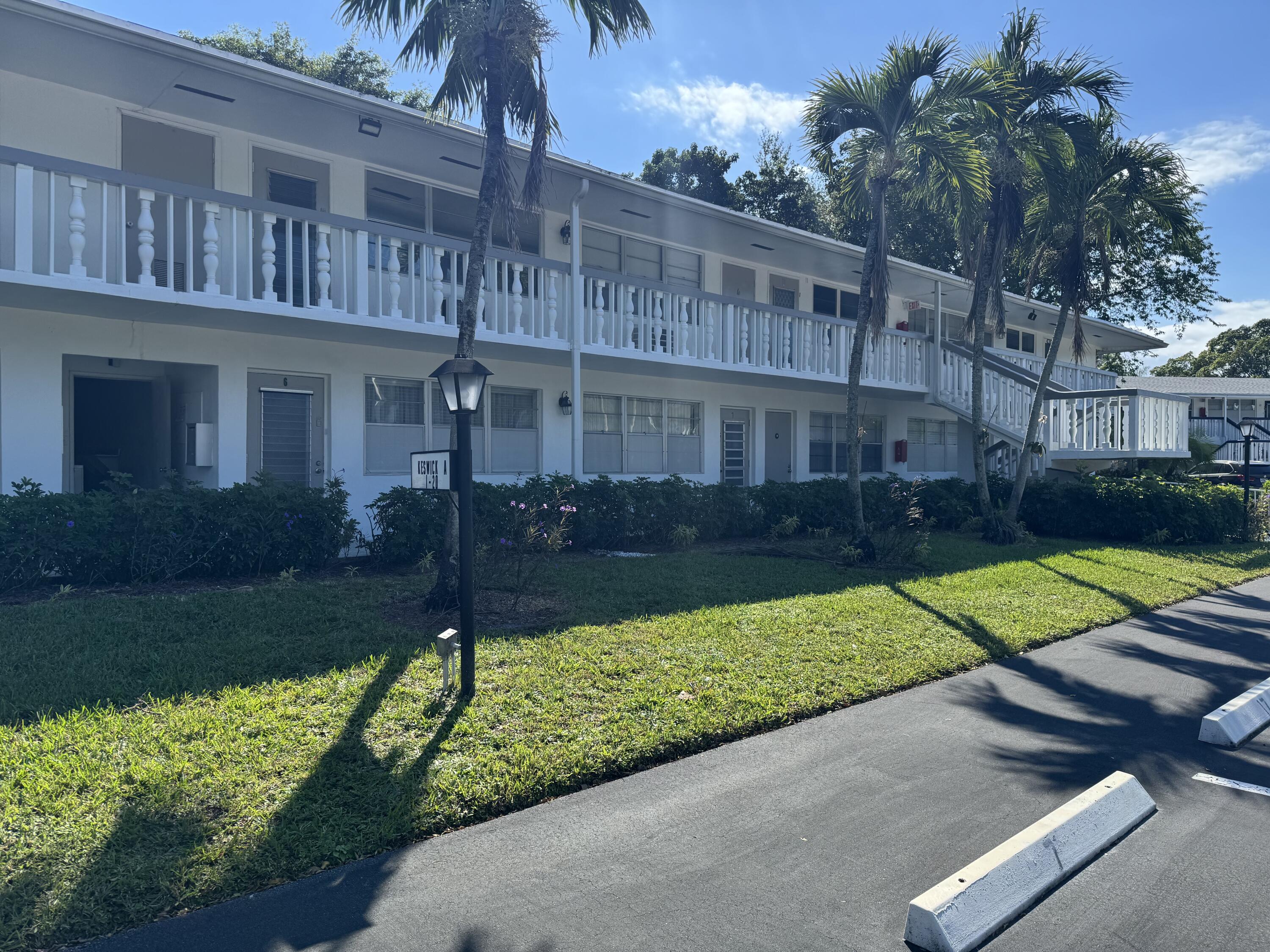 a view of backyard with potted plants and a bench