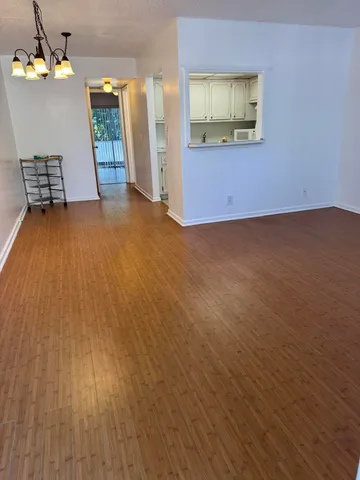 a view of a room with wooden floor