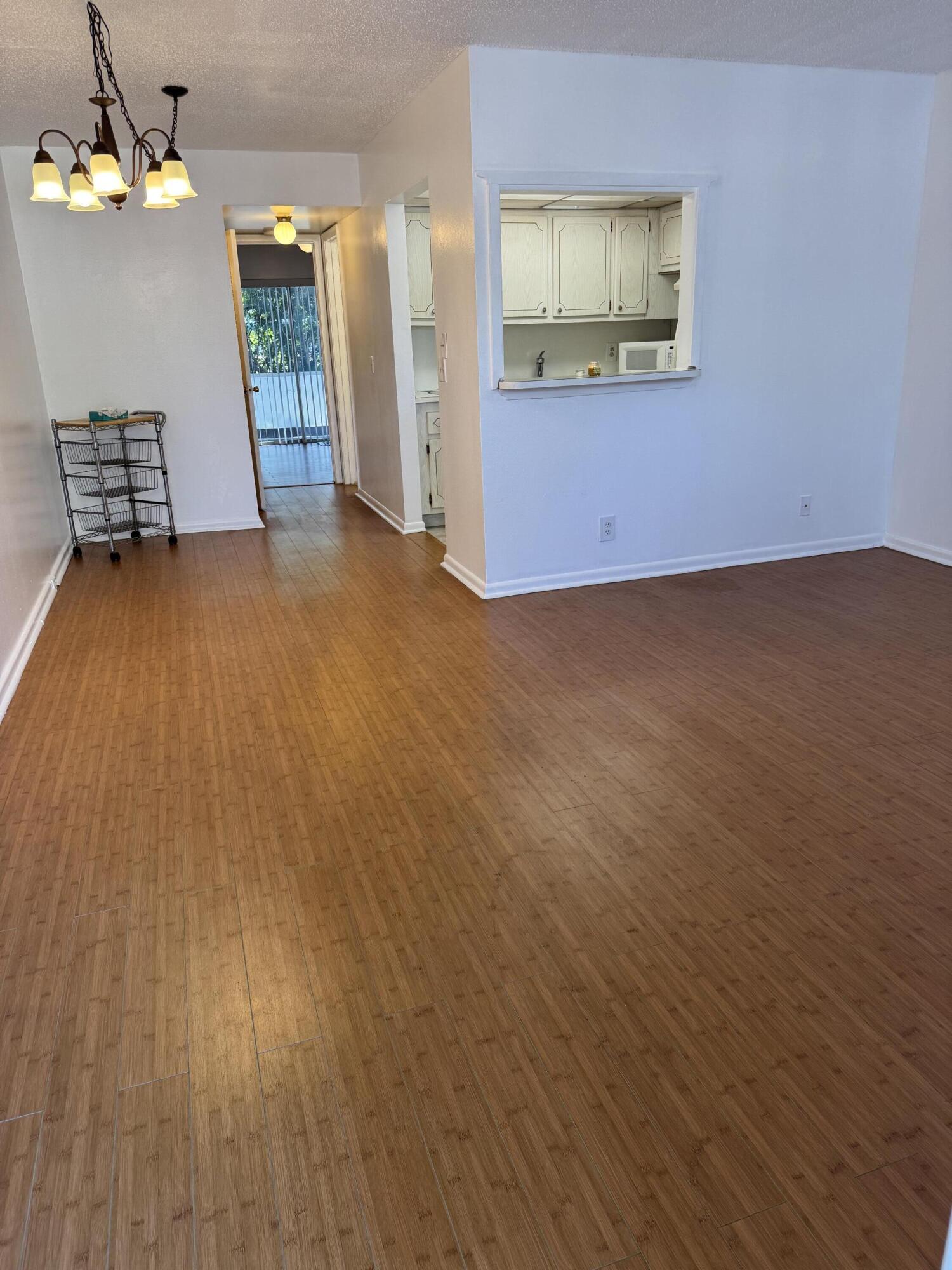 6 Keswick A, Unit 6 Deerfield Beach, FL 33442 - Photo 4 of 17 a view of a room with wooden floor