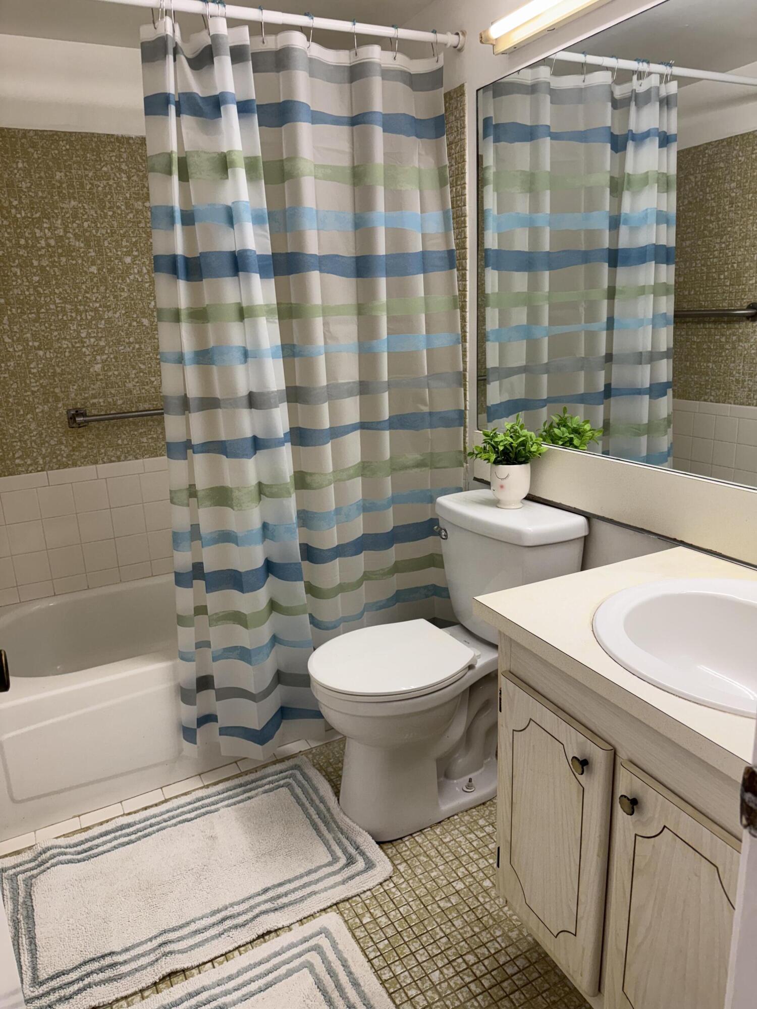 6 Keswick A, Unit 6 Deerfield Beach, FL 33442 - Photo 6 of 17 a bathroom with a toilet a sink and shower