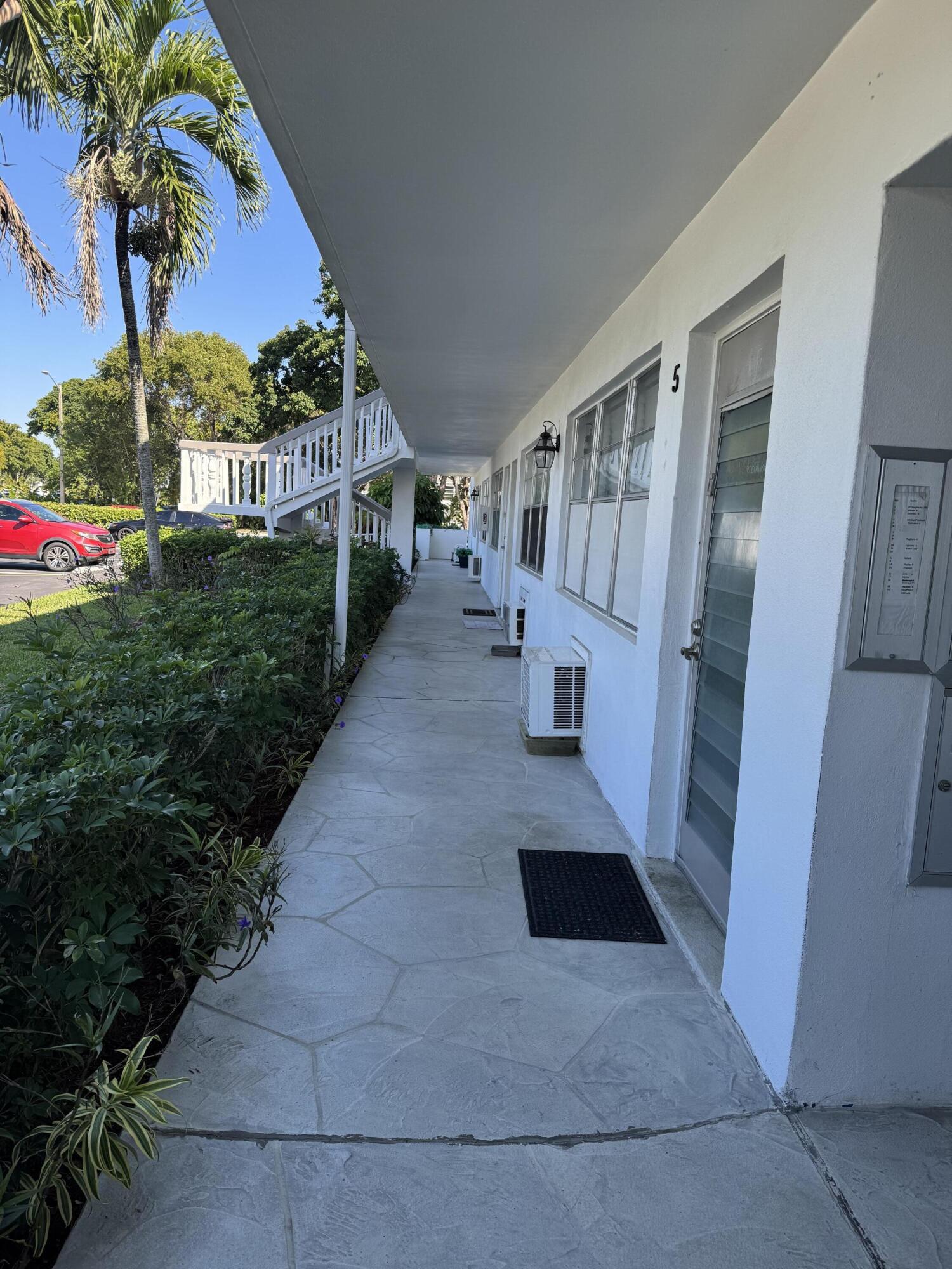 6 Keswick A, Unit 6 Deerfield Beach, FL 33442 - Photo 9 of 17 a view of living room with a yard and potted plants