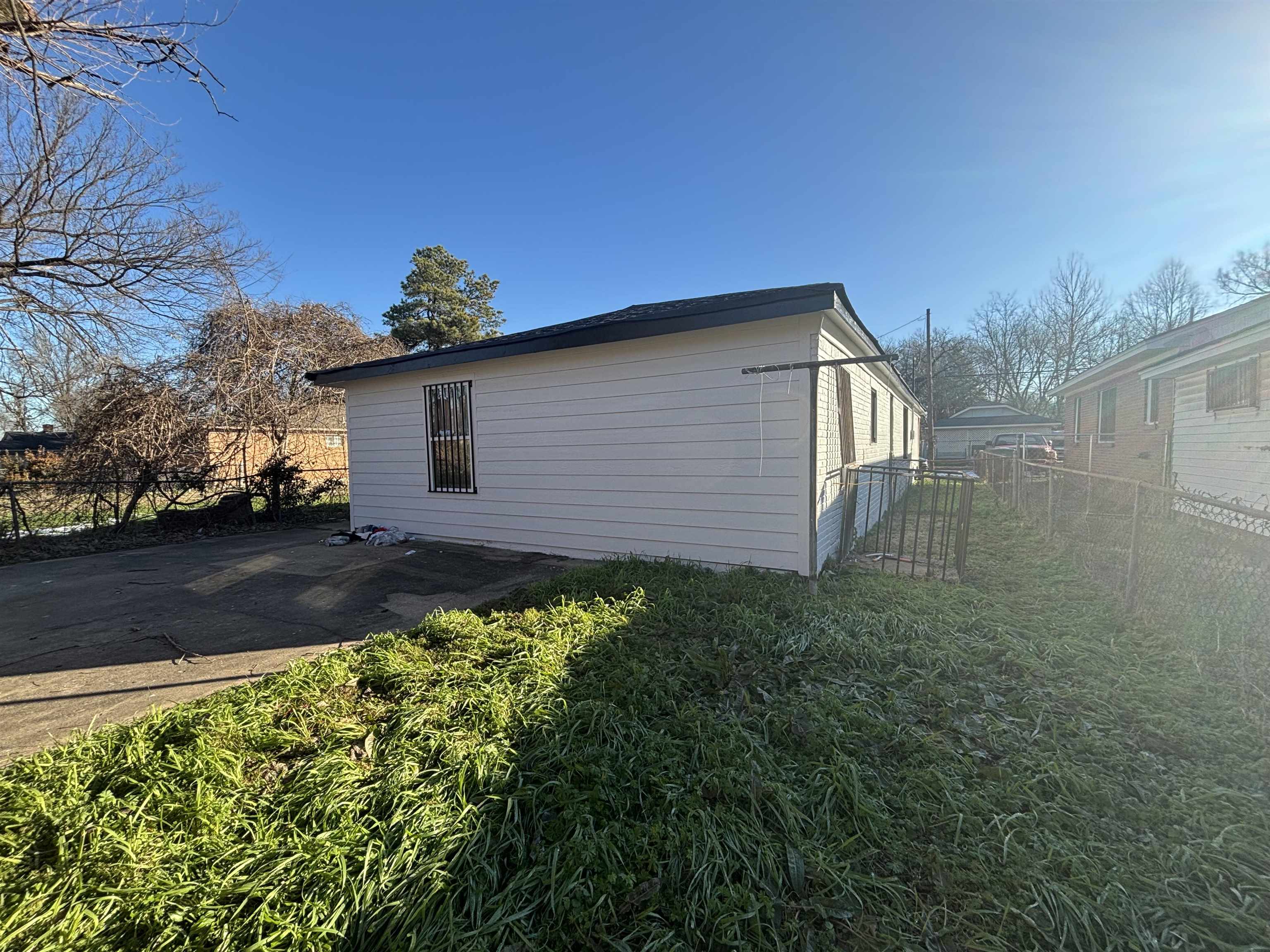 1489 Boxwood Street Memphis, TN 38108 - Photo 3 of 12 a view of a backyard with potted plants