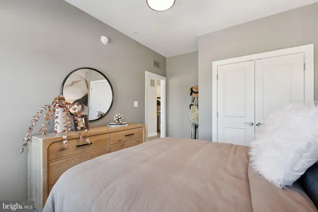 a bedroom with a bed and a dresser