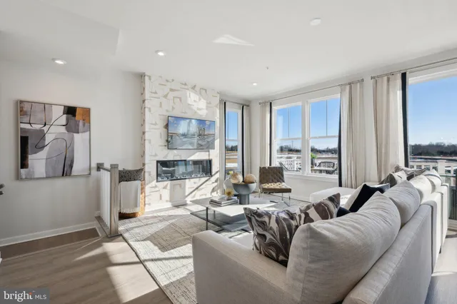 a living room with furniture large window and a table