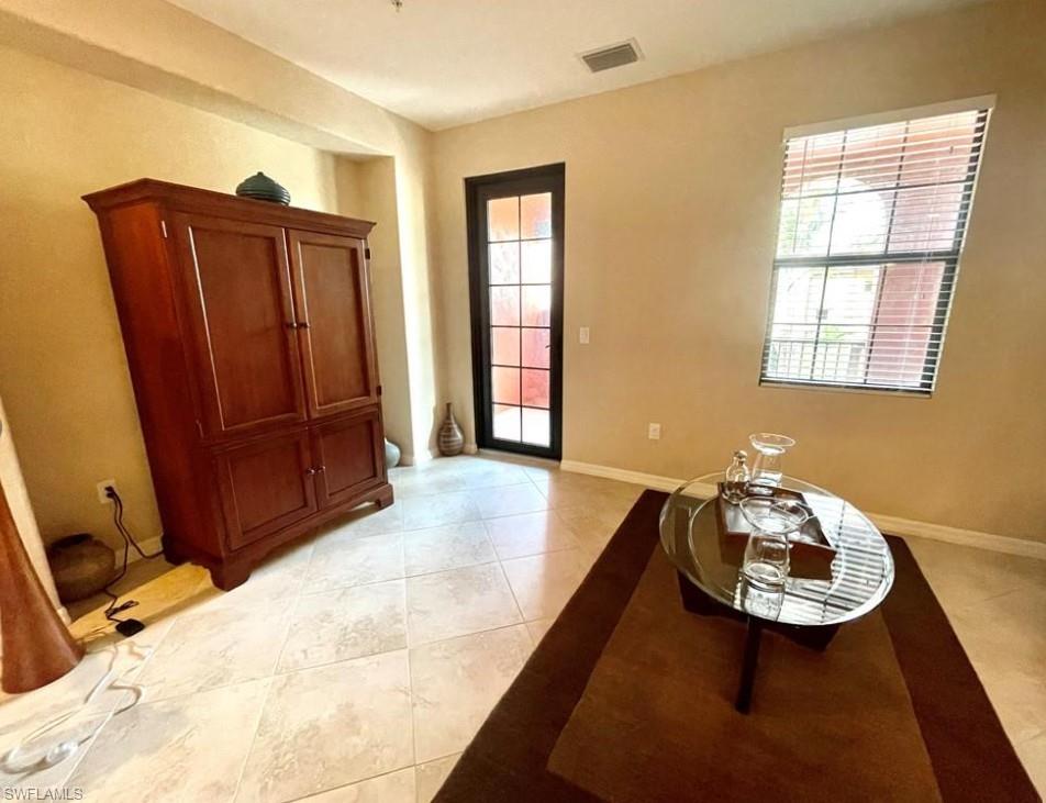 9050 Capistrano Street North, Unit 4102 Naples, FL 34113 - Photo 10 of 31 a view of a livingroom with furniture and front door