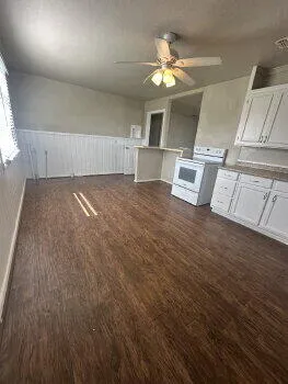 wooden floor in an empty room with a fireplace