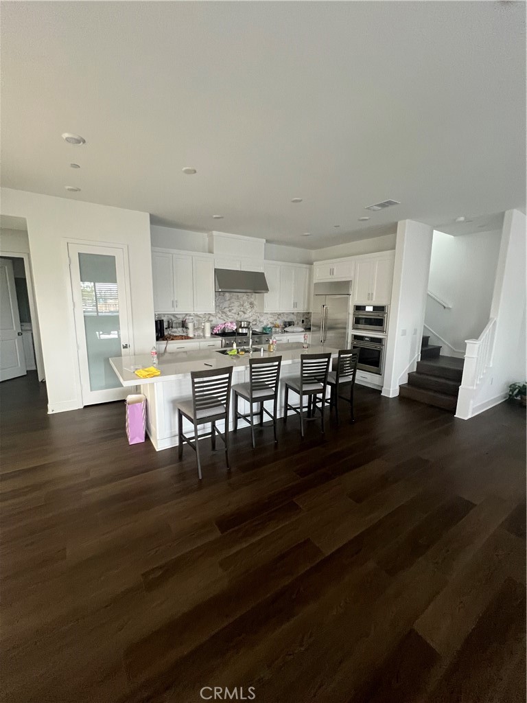 524 Gadwall Irvine, CA 92618 - Photo 18 of 24 a living room with lots of wooden furniture and a table