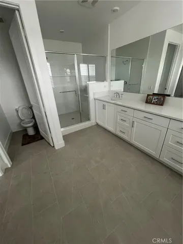a bathroom with a double vanity sink and mirror