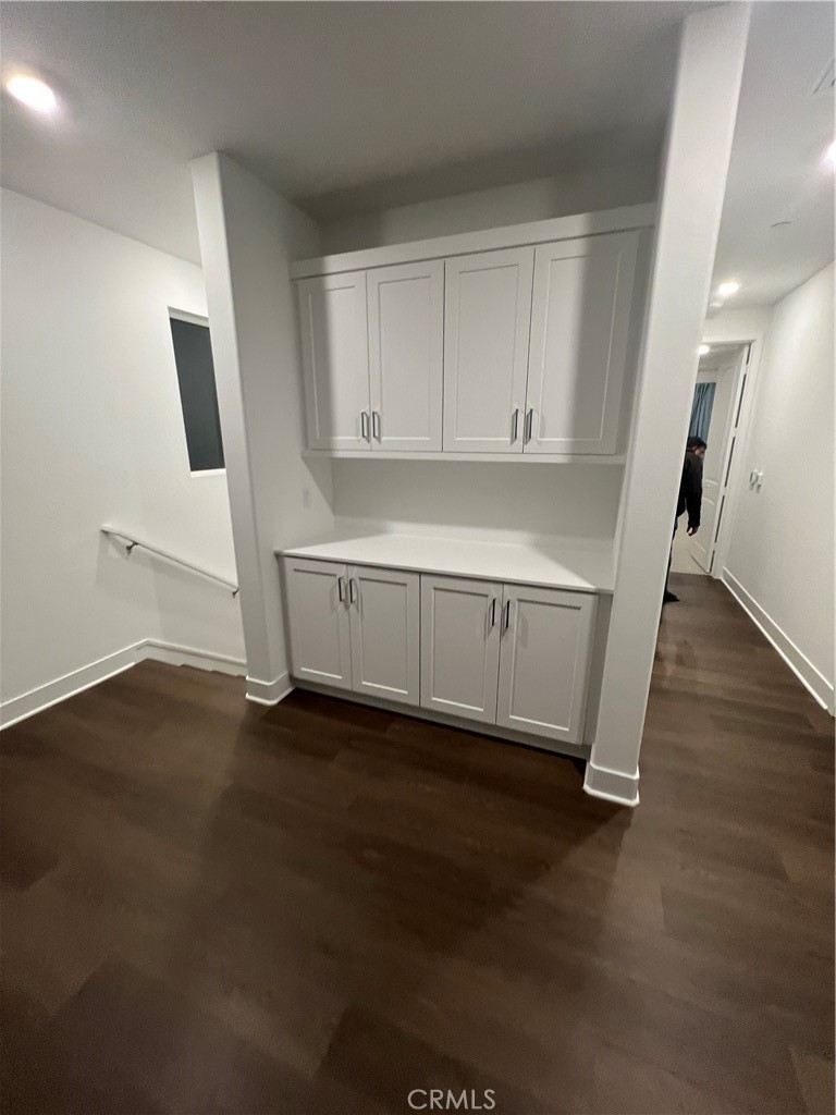 524 Gadwall Irvine, CA 92618 - Photo 10 of 24 an empty room with wooden floor and cabinet