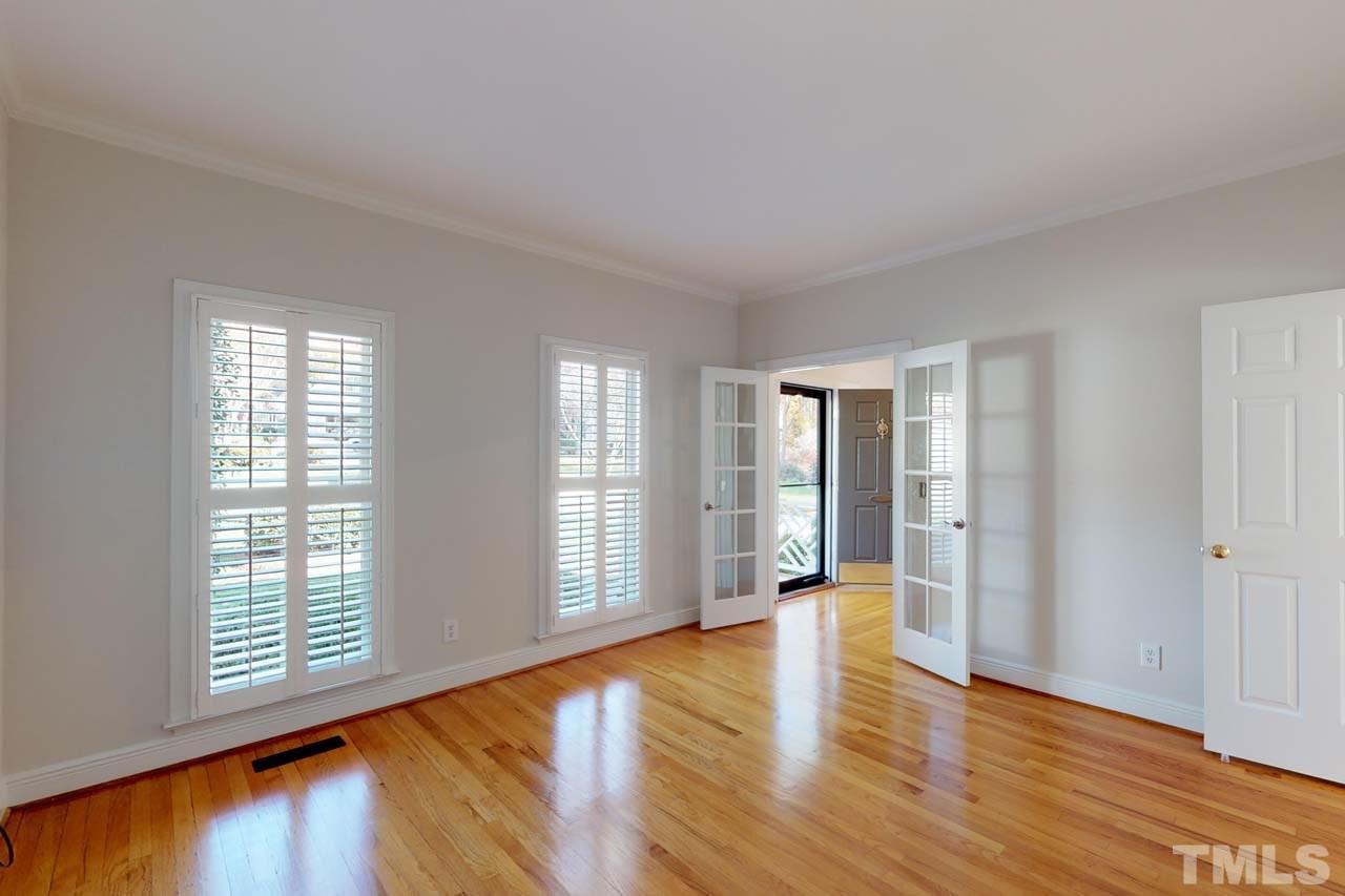 8601 Stanton Place Raleigh, NC 27615 - Photo 12 of 25 This space has French doors onto the foyer and a solid door that separates the family room. It functions as a great home office or additional living space on the 1st floor.