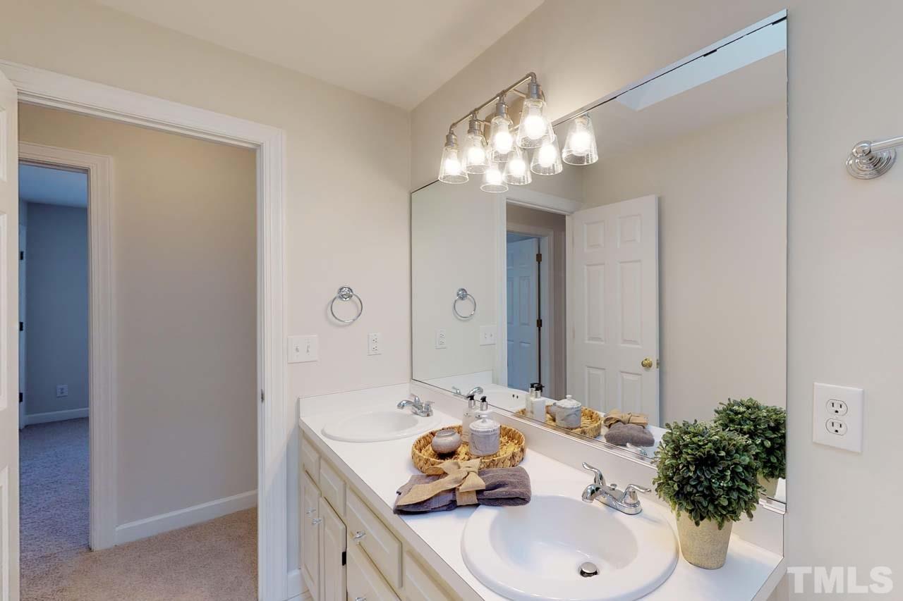 8601 Stanton Place Raleigh, NC 27615 - Photo 18 of 25 The hall bath features double vanity and a tub shower/ combo. The transom window and large sky light make this room bright and a great place to start your day!