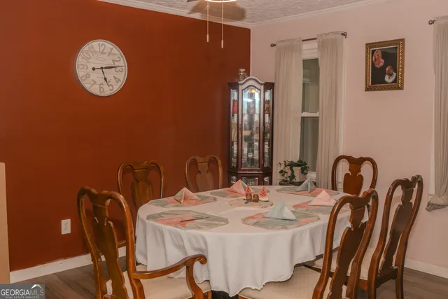 a dining room with furniture and a mirror