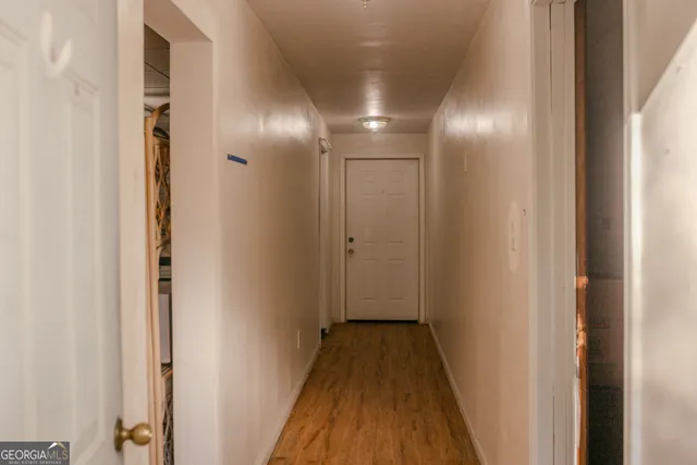 a view of hallway with wooden floor