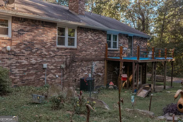 a view of a house with a patio and a yard