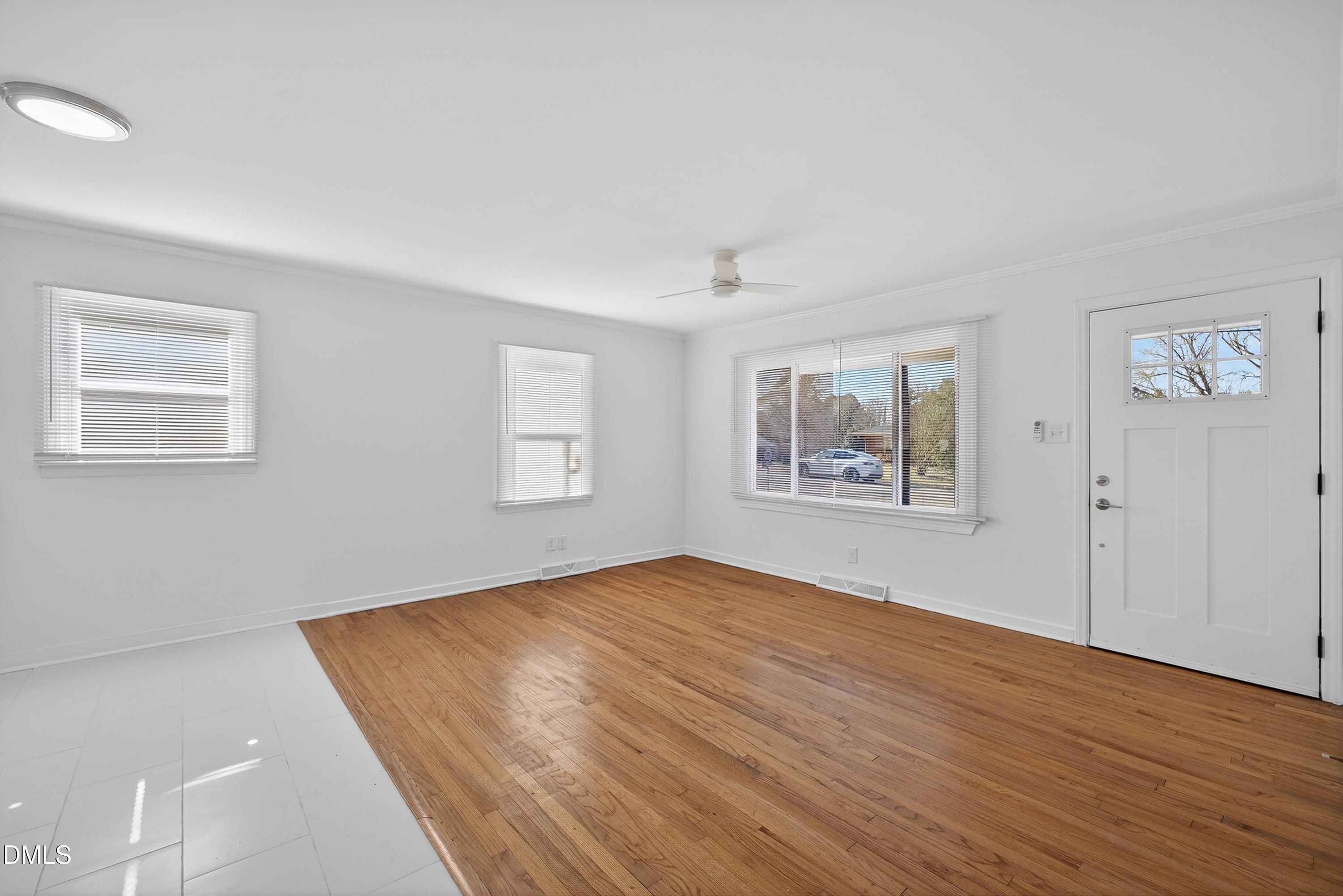302 Normandy Street Durham, NC 27707 - Photo 5 of 29 a view of an empty room with wooden floor and a window