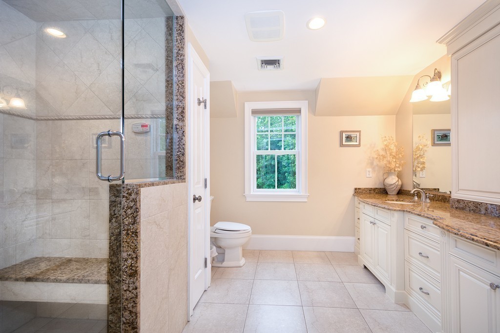 60 Powder Point Avenue Duxbury, MA 02332 - Photo 19 of 30 a bathroom with a granite countertop sink a toilet a mirror and shower