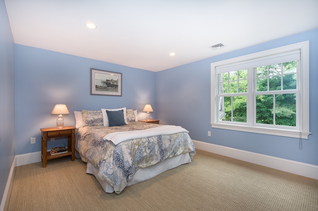 60 Powder Point Avenue Duxbury, MA 02332 - Photo 21 of 30 a spacious bedroom with a bed and a window