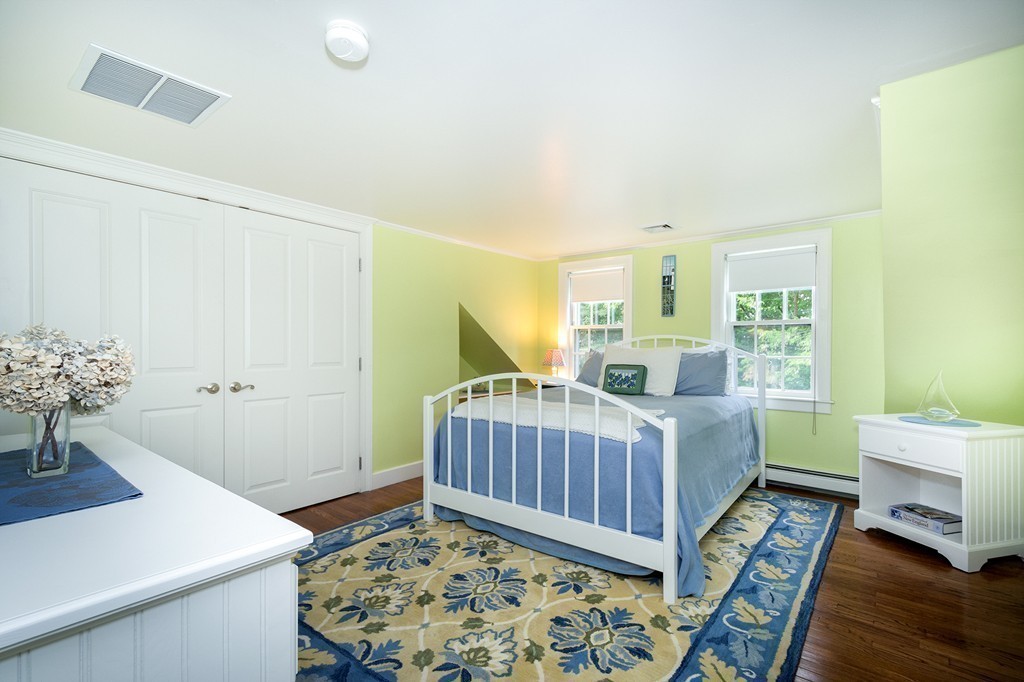 60 Powder Point Avenue Duxbury, MA 02332 - Photo 23 of 30 a bed room with a bed and a table