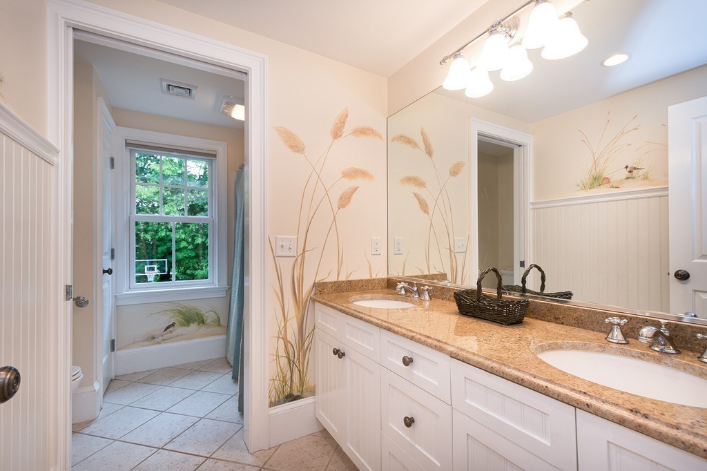 60 Powder Point Avenue Duxbury, MA 02332 - Photo 24 of 30 a bathroom with a double vanity sink and a mirror