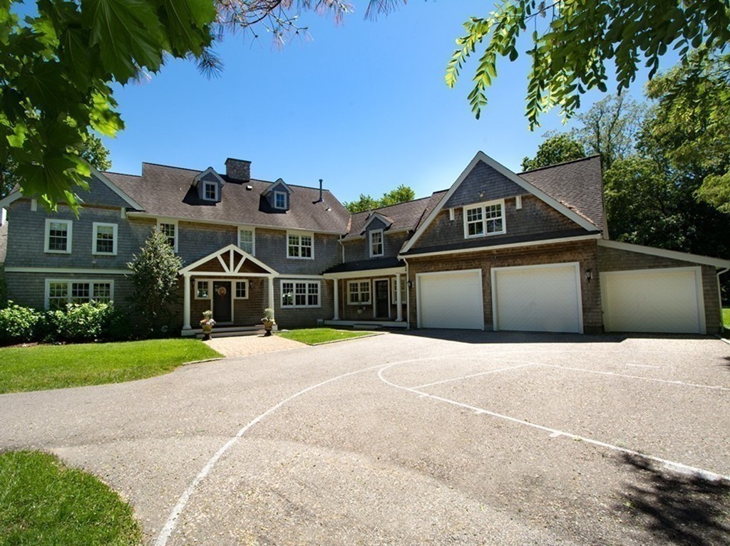 60 Powder Point Avenue Duxbury, MA 02332 - Photo 5 of 30 a front view of a house with a yard and garage