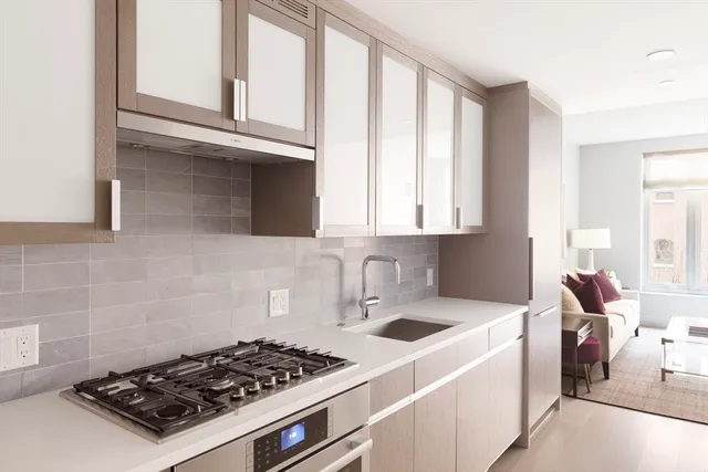 a kitchen with a stove a sink and a cabinets