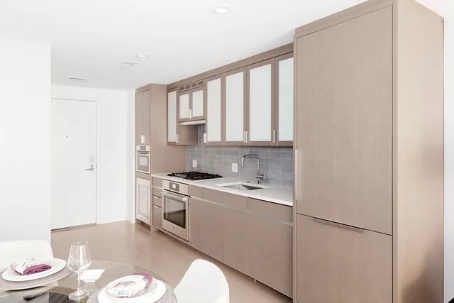 a kitchen with a sink appliances and cabinets