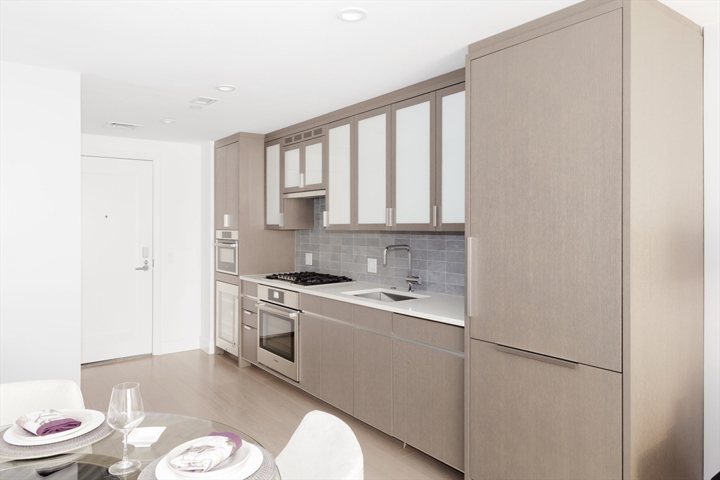 100 Lovejoy Wharf, Unit 7P Boston, MA 02114 - Photo 4 of 22 a kitchen with a sink appliances and cabinets