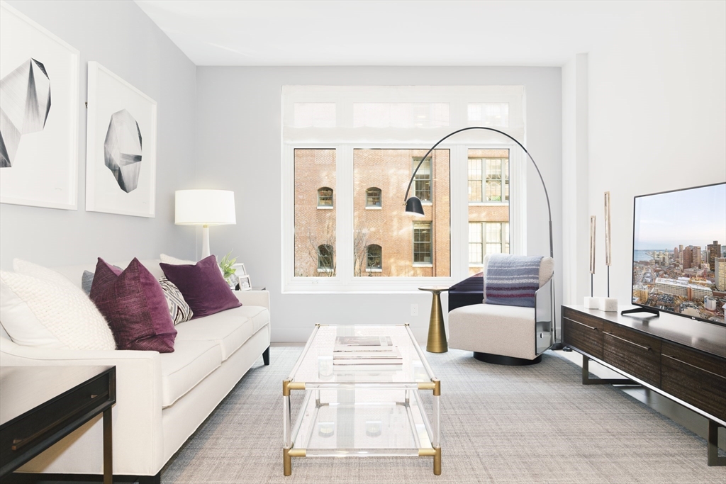 100 Lovejoy Wharf, Unit 7P Boston, MA 02114 - Photo 6 of 22 a living room with furniture and a large window