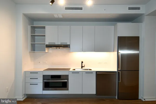 a kitchen with cabinets and stainless steel appliances