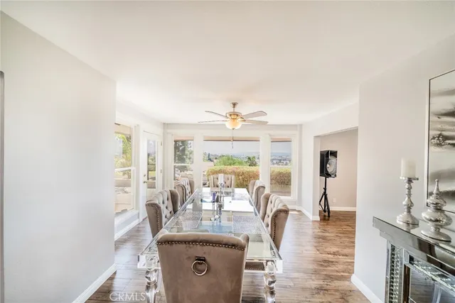 a living room with fireplace furniture and a large window