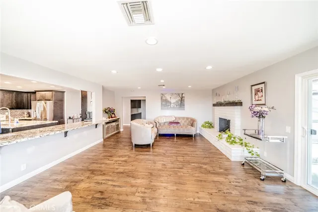 a bathroom with a granite countertop sink and a large mirror