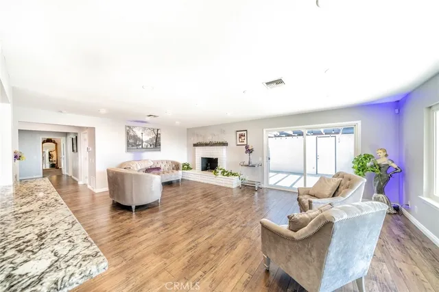 a kitchen with stainless steel appliances granite countertop a sink and a refrigerator